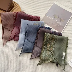 Elegant striped floral silk scarves in assorted colors on a textured white background