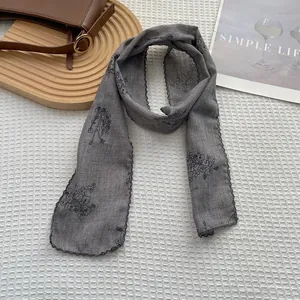 Close-up of vintage floral cotton linen scarf with delicate lace edging and grey flower pattern
