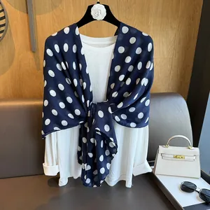 French retro style navy blue scarf with white polka dots paired with accessories