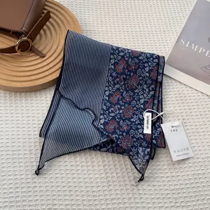Striped neck scarf with floral print and brand label on white waffle fabric texture
