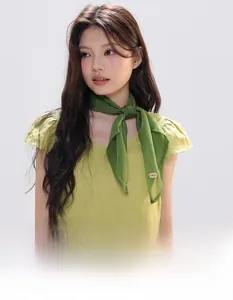 Forest green silk-like scarf tied in a neck knot style over a yellow cotton dress