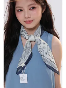 Detail of paisley ramie scarf showing fine fabric texture and premium brand label