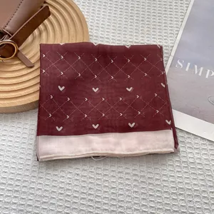Burgundy heart print silk square scarf on elegant waffle texture background for women