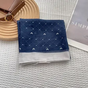 Close-up of heart pattern silk scarf with contrast edge and premium stitching