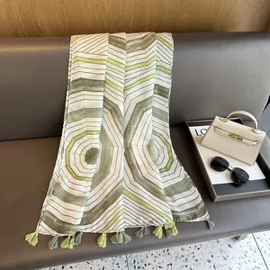 Close-up of geometric striped scarf featuring fringe tassels and modern abstract patterns