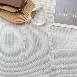 Detail van de elegante witte kanten streamer met verfijnde geborduurde bloempatronen