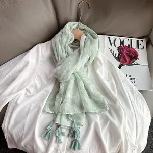 Light green linen floral scarf with tassels and white flower patterns for summer sun protection
