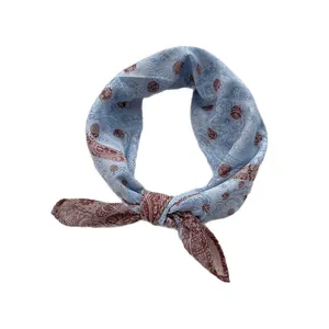 Classic paisley printed light blue silk scarf tied in a stylish ring knot for women