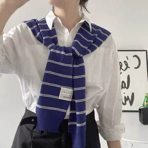 Detail showing high-quality navy blue and white striped knit fabric and brand label