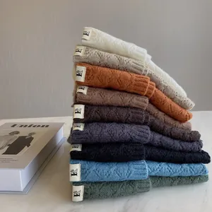 Close-up of knit fabric textures and colorful pile socks with a small puppy logo label