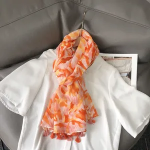 Linen-feel cotton scarf with orange and pink graffiti print and fringe trim for summer