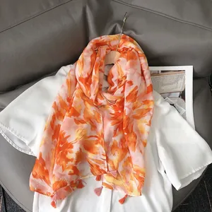 Chic linen-feel shawl with orange abstract floral prints and fringe tassels for summer