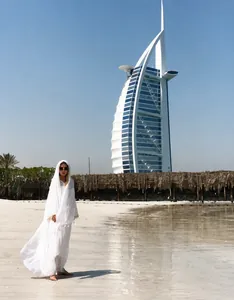 White hooded cotton linen kaftan shawl shown against the Burj Al Arab beach backdrop