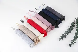 Detailed view of assorted linen scarves with delicate lace inserts and fringe trim