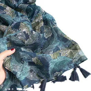 Linen paisley scarf with fringe tassels shown in detailed hand-held view for texture
