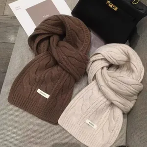 Thick twisted knit wool scarves in brown and beige colors with a warm premium texture