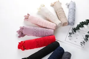 Detail of assorted color linen shawls with delicate lace embroidery and tassels