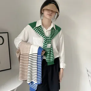Close-up of striped knit shawl variety in green, blue, and black for summer layering