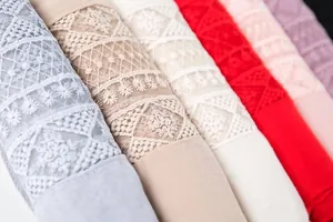 Close-up of multi-colored cotton linen scarves with intricate hollow lace flower patterns