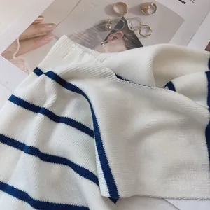 Close-up of the high-quality blue and white striped knit texture and soft fabric