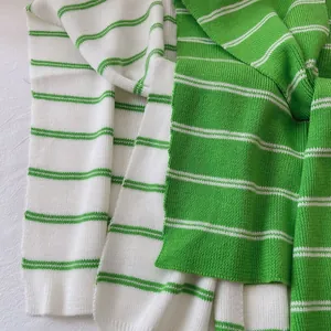 Close-up of the green and white striped knitted texture on a lightweight shawl wrap