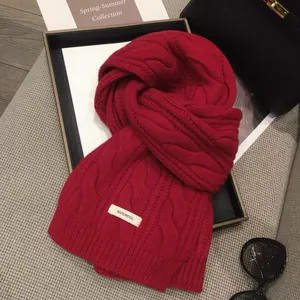 Luxurious red 100% wool knitted scarf with cable knit pattern and ribbed edges