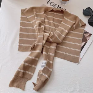 Classic brown and white striped knit shawl wrap with front button in minimalist French style