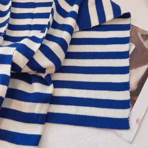 Close-up of nautical striped knitted scarf featuring royal blue and white ribbed texture
