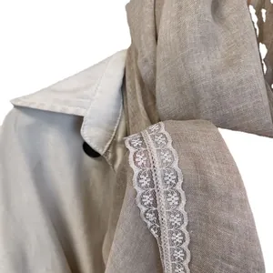 Linen cotton lace scarf in light coffee brown layered on a beige trench coat collar