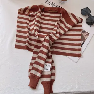 Detail of classic brown and beige striped knitted shawl wrap with brand woven label