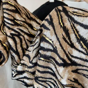Brown zebra print scarf with gold foil details and soft cotton linen texture