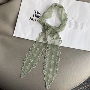 Detailed embroidery on light green lace skinny scarf with delicate wavy edges