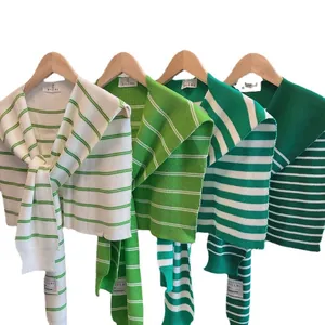 Lightweight striped knit shawls in various green tones for seasonal layering