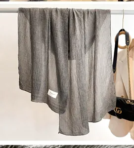 Close-up of deep grey pleated cotton linen scarf with a soft vertical crinkle texture