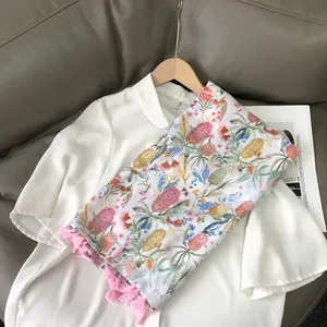 Japanese style white cotton linen top paired with floral print tassel scarf on sofa