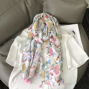Floral print cotton-linen shawl with tropical patterns and pink tassels for sun protection