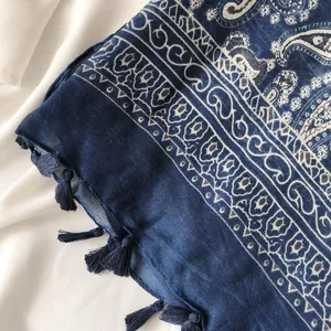 Detailed view of navy blue paisley scarf with elegant fringe tassels and vintage patterns
