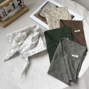 Linen floral triangle headscarves in assorted colors shown with 100% linen label