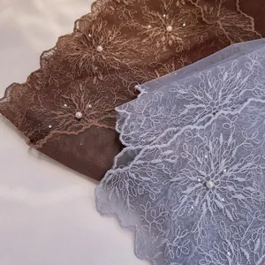 Detailed close-up of vintage lace scarves with 3D floral embroidery and white pearls