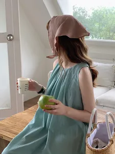 Detail of light green pleated linen top with vertical texture and elegant sleeveless cut