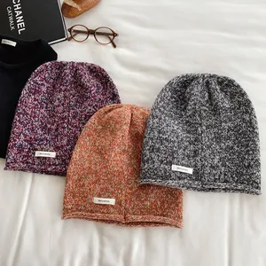 Three premium 100% pure wool knitted beanies in purple, orange, and grey colors