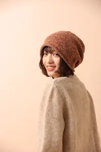 Close-up of orange wool knit beanie with thick ribbed texture and warm slouchy fit