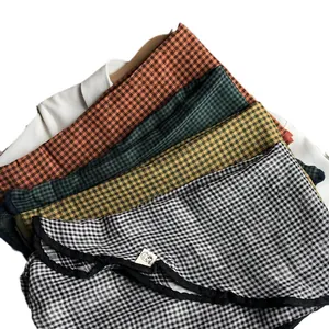 Japanese style cotton gingham scarves in four colors layered on a wooden hanger