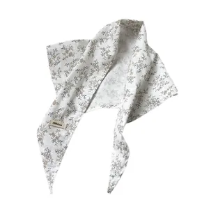 Minimalist 100% linen triangle scarf with brown floral pattern on a warm white base