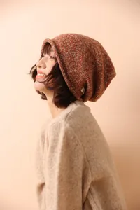 Close-up of orange and white wool knit beanie worn by a female model for winter style