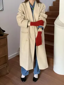 Detail of red knit touchscreen gloves paired with a wool coat and blue denim shirt