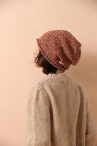 Detail of soft knit texture on a 100% wool orange and grey speckled beanie hat