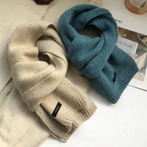 Knitted 100% wool scarves in beige and dark teal with ribbed edges and soft texture