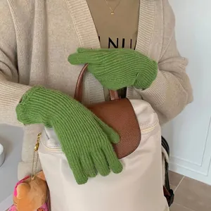 Detail of green knit touchscreen gloves with ribbed texture for cold weather warmth