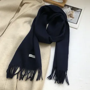 Detail of navy blue 100% Australian wool scarf with long tassels and soft knit texture